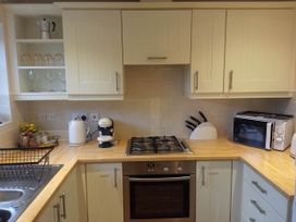 A kitchen with cabinets and appliances at Ground Floor Cornish Retreat Free Parking Bodmin