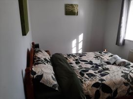 A bedroom with a bed and wall decor at Ground Floor Cornish Retreat Free Parking Bodmin