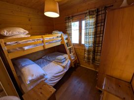A bedroom with bunk bed and double bed at Pet Friendly - Lodge at Riverview Holiday Park, Mangerton near Newcastleton