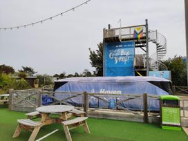 An outdoor area with a spiral staircase and inflatable landing at 8Berth- SmartTV- CloseToBeach- FamilyFriendly in Mablethorpe