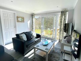 A living room with a sofa and coffee table at 8Berth- SmartTV- CloseToBeach- FamilyFriendly in Millendreath near Looe