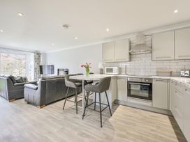 A kitchen with a seating area and TV at 8Berth- SmartTV- CloseToBeach- FamilyFriendly in Millendreath near Looe