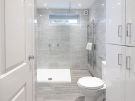 A bathroom with a shower, toilet, and towel rack at 8Berth- SmartTV- CloseToBeach- FamilyFriendly, Millendreath near Looe