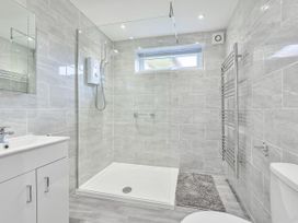 A bathroom featuring a shower, toilet, and sink at 8Berth- SmartTV- CloseToBeach- FamilyFriendly in Millendreath near Looe