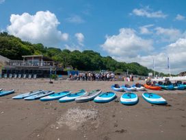 Paddleboards on a beach with people in the background at 8Berth- SmartTV- CloseToBeach- FamilyFriendly, Millendreath near Looe