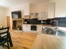 A kitchen with countertop, sink, oven, and microwave at Foundry Farm Apartment