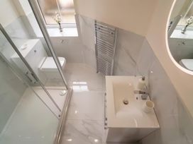 A bathroom with a sink and toilet at Foundry Farm Apartment
