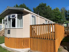 A static caravan with a wooden deck at Static Caravan 2 Bedrooms - sleeps 4 in Hawick