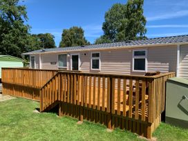 A caravan with wooden decking and handrails at Static Caravan 2 Bedrooms - sleeps 4 Hawick