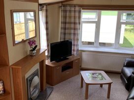 A living room with a television and fireplace at Static Caravan 2 Bedrooms - sleeps 4 Hawick