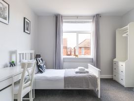 A bedroom with a bed and a desk at Lily Apartment - Sleeps 3 - Pet friendly - Parking in Bedlington