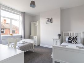 A bedroom with two beds and a wardrobe at Lily Apartment - Sleeps 3 - Pet friendly - Parking in Bedlington