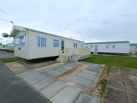 A mobile home with steps and a satellite dish at 3 Bed, Sleeps 6, Parking