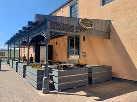An outdoor seating area with tables and chairs at o'neill's Irish Bar