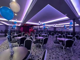 An event hall with tables and chairs decorated with balloons at 3 Bed, Sleeps 6, Parking