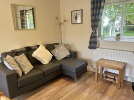 A living room with a sofa and a small table at TBC