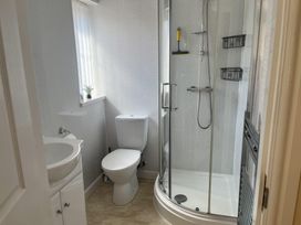 A bathroom with a shower toilet and sink at TBC in 