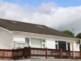 A house with a balcony and windows at The Cartwheel in Amroth