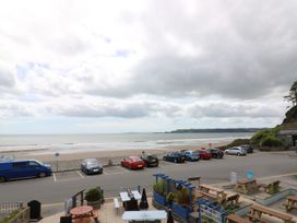 A view of the sea and parking lot with tables at The Cartwheel in Amroth