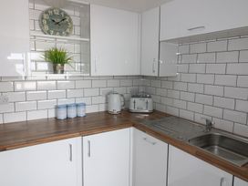 A kitchen with a kettle, toaster and canisters at The Cartwheel in Amroth
