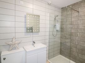 A bathroom with a sink and a shower at The Cartwheel in Amroth