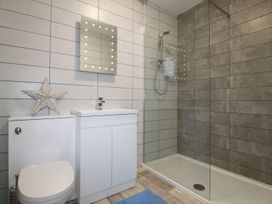 A bathroom with a shower and sink at The Cartwheel in Amroth