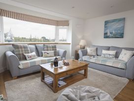A living room with sofas and a coffee table at 6 Knowle Court in Salcombe