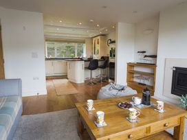 A living room with a couch and coffee table at 6 Knowle Court in Salcombe