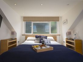 A bedroom with a bed and breakfast tray at 6 Knowle Court in Salcombe