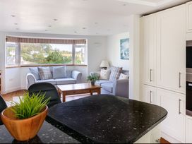 A living room with a sofa and coffee table at 6 Knowle Court in Salcombe