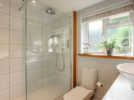 A bathroom with a shower, toilet, and sink at 6 Knowle Court in Salcombe