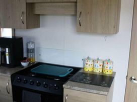 A kitchen with appliances and storage at 84 Sandhills in Ingoldmells