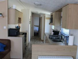 A kitchen with cabinets and appliances at 84 Sandhills in Ingoldmells