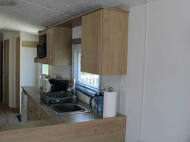 A kitchen with a sink and cupboards at 84 Sandhills Ingoldmells