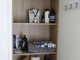 A shelf with toiletries and towels at 84 Sandhills in Ingoldmells