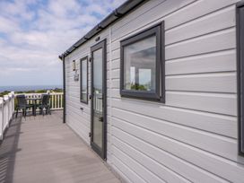 An outdoor area with a table and chairs at The Dorchester at Bay View New Quay