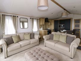 A living room with sofas and a coffee table at The Dorchester at Bay View in New Quay