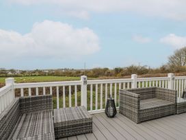 An outdoor seating area with furniture and a view of fields at The Dorchester at Bay View Maen-y-groes near New Quay