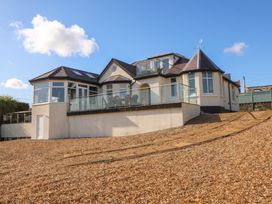 A house with a balcony and multiple windows at Hillside 
