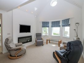 A living room with a television and armchairs at Hillside