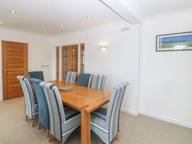 A dining room with a wooden table and chairs at Hillside