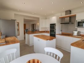 A kitchen with white cabinets and wooden countertops at Hillside