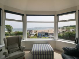 A living room with views of the sea and beach at Hillside