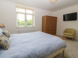 A bedroom with a bed wardrobe and television at Hillside