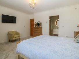 A bedroom with a bed, chair, and television at Hillside