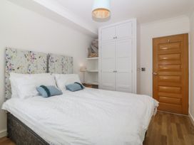 A bedroom with a bed and wardrobe at Hillside 
