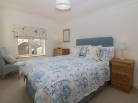 A bedroom with a bed and a chair at Hillside
