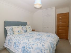 A bedroom with a bed and wardrobe at Hillside