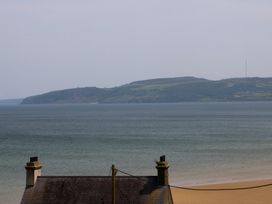 A view of a beach and hills from a house at Hillside in 