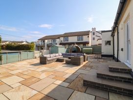 A patio area with an outdoor sofa and tables at Hillside